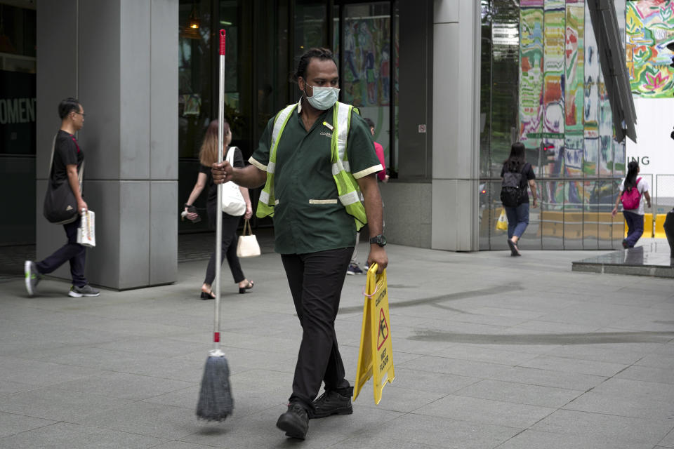 SINGAPORE, SINGAPORE - FEBRUARY 28: A maintainance worker wearing a mask walks past the Central Business District on February 28, 2020 in Singapore. The coronavirus, originating in Wuhan, China has spread to over 80,000 people globally, more than 50 countries have now been infected.  (Photo by Ore Huiying/Getty Images)