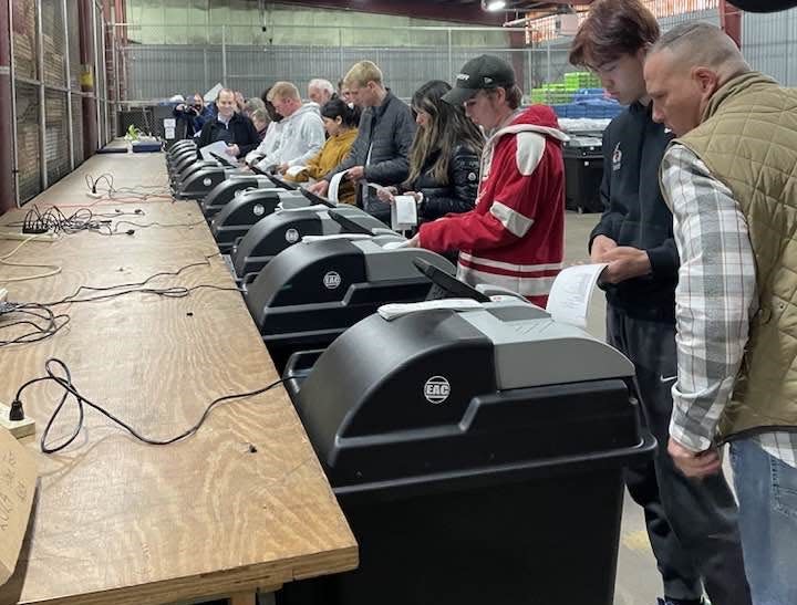 Holy Cross College students help to test voting machines in a county warehouse Wednesday, April 3, 2024, at the meeting of the St. Joseph County Election Board.