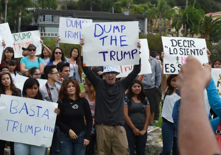People march during a protest rally denouncing alleged racist remarks by Republican presidential candidate Donald Trump, at the Trump National Golf Club in Palos Verdes, California on October 17, 2015 (AFP Photo/Mark Ralston)