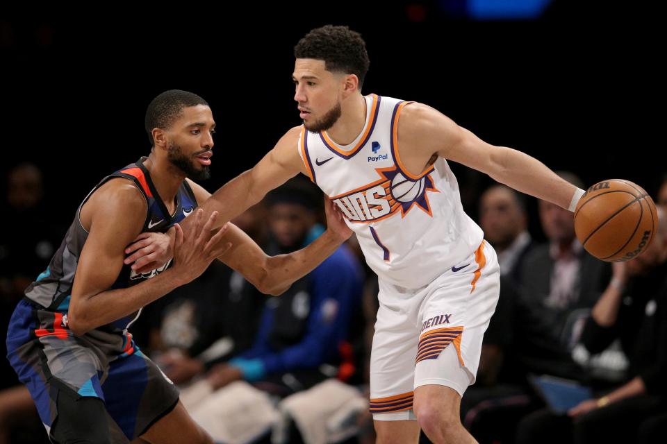 Suns guard Devin Booker, who played at Kentucky, was included among John Wall and DeMarcus Cousins' top UK starting fives that could win an NBA title together.