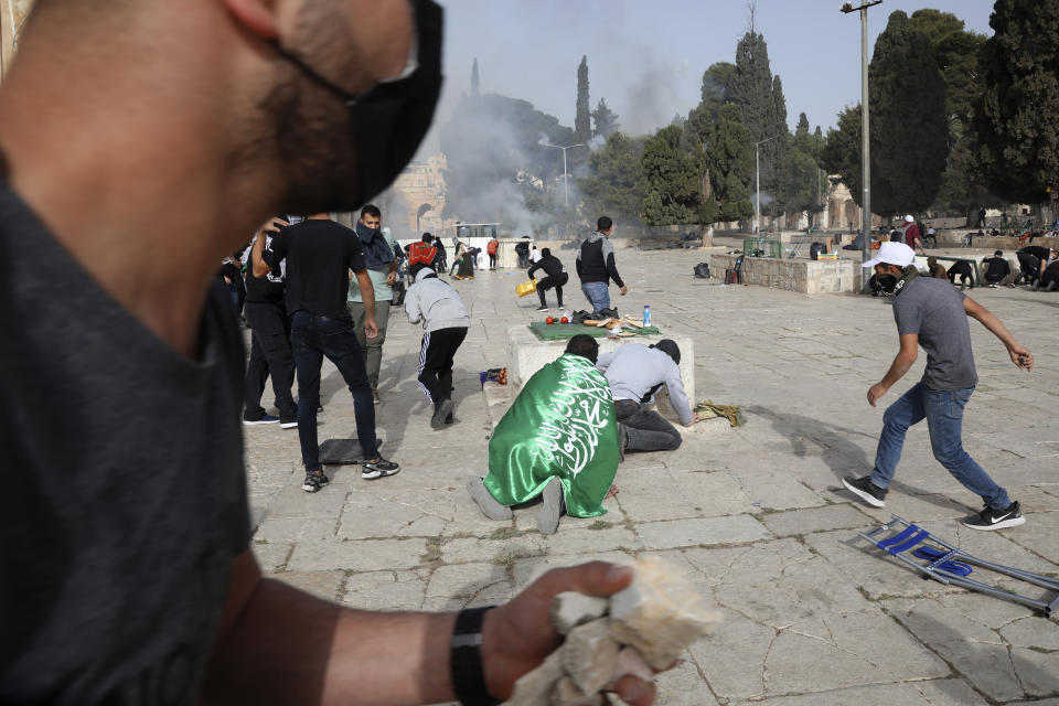 Palestinians clash with Israeli security forces at the Al Aqsa Mosque compound in Jerusalem's Old City Monday, May 10, 2021. Israeli police clashed with Palestinian protesters at a flashpoint Jerusalem holy site on Monday, the latest in a series of confrontations that is pushing the contested city to the brink of eruption. Palestinian medics said at least 180 Palestinians were hurt in the violence at the Al-Aqsa Mosque compound, including 80 who were hospitalized. (AP Photo/Mahmoud Illean)