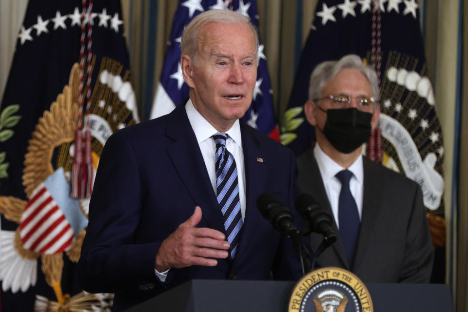 President Biden, at the White House on Thursday, speaks as Attorney General Merrick Garland, wearing a mask, listens.