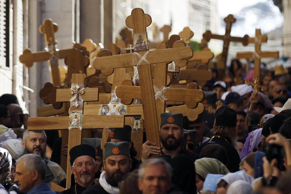 Christian worshippers hold crosses as they walk in a procession along the Via Dolorosa on Good Friday during Holy Week in Jerusalem's Old City April 18, 2014. Christian worshippers on Friday retraced the route Jesus took along Via Dolorosa to his crucifixion in the Church of the Holy Sepulchre. Holy Week is celebrated in many Christian traditions during the week before Easter.