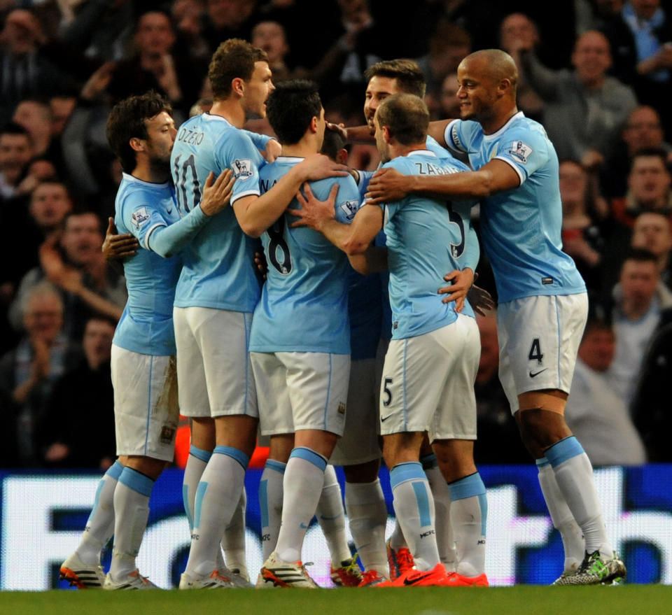 Manchester City players celebrate after Sergio Aguero scored against West Bromich Albion during their English Premier League soccer match at the Etihad Stadium, Manchester, England, Monday April 21, 2014. (AP Photo/Rui Vieira)