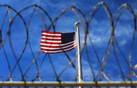 FILE PHOTO: The U.S. flag flies over Camp VI, a prison used to house detainees at the U.S. Naval Base at Guantanamo Bay