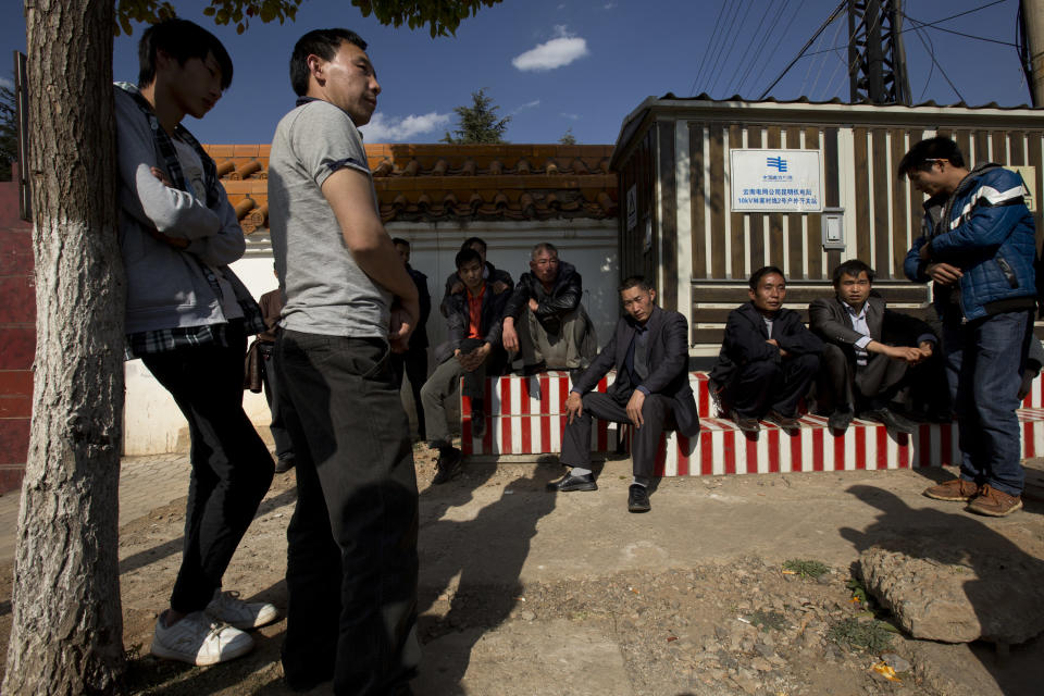 Relatives and friends of a victim killed in Saturday night's attack wait to see the victim's body outside a funeral home in Kunming, in southwestern China's Yunnan province, Monday, March 3, 2014. Twenty-nine slash victims and four attackers were killed and 143 people wounded in the attack which officials said was a terrorist assault by ethnic separatists from the far west. (AP Photo/Alexander F. Yuan)