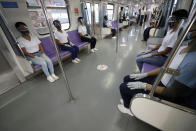 Police trainees sit inside a train carriage during a simulation exercise for proper social distancing at the LRT-2 station on Tuesday, May 26, 2020 in Manila, Philippines. The exercise is held to prepare for the possible resumption of public transportation as the community lockdown to prevent the spread of the new coronavirus might be more relaxed next week. (AP Photo/Aaron Favila)