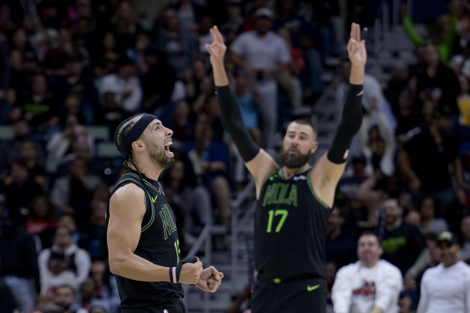 New Orleans Pelicans guard Jose Alvarado, left, celebrates next to center Jonas Valanciunas (17) after a score against the Miami Heat during the first half of an NBA basketball game in New Orleans, Friday, Feb. 23, 2024. (AP Photo/Matthew Hinton)