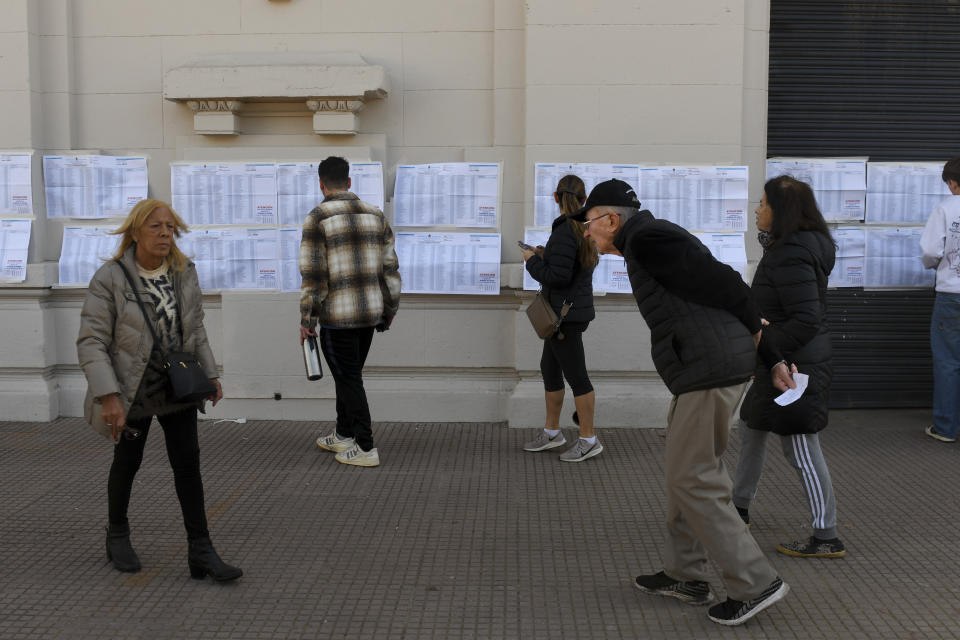 Voters look for their voting polling station during primary elections in Buenos Aires, Argentina, Sunday, Aug. 13, 2023.(AP Photo/Gustavo Garello)