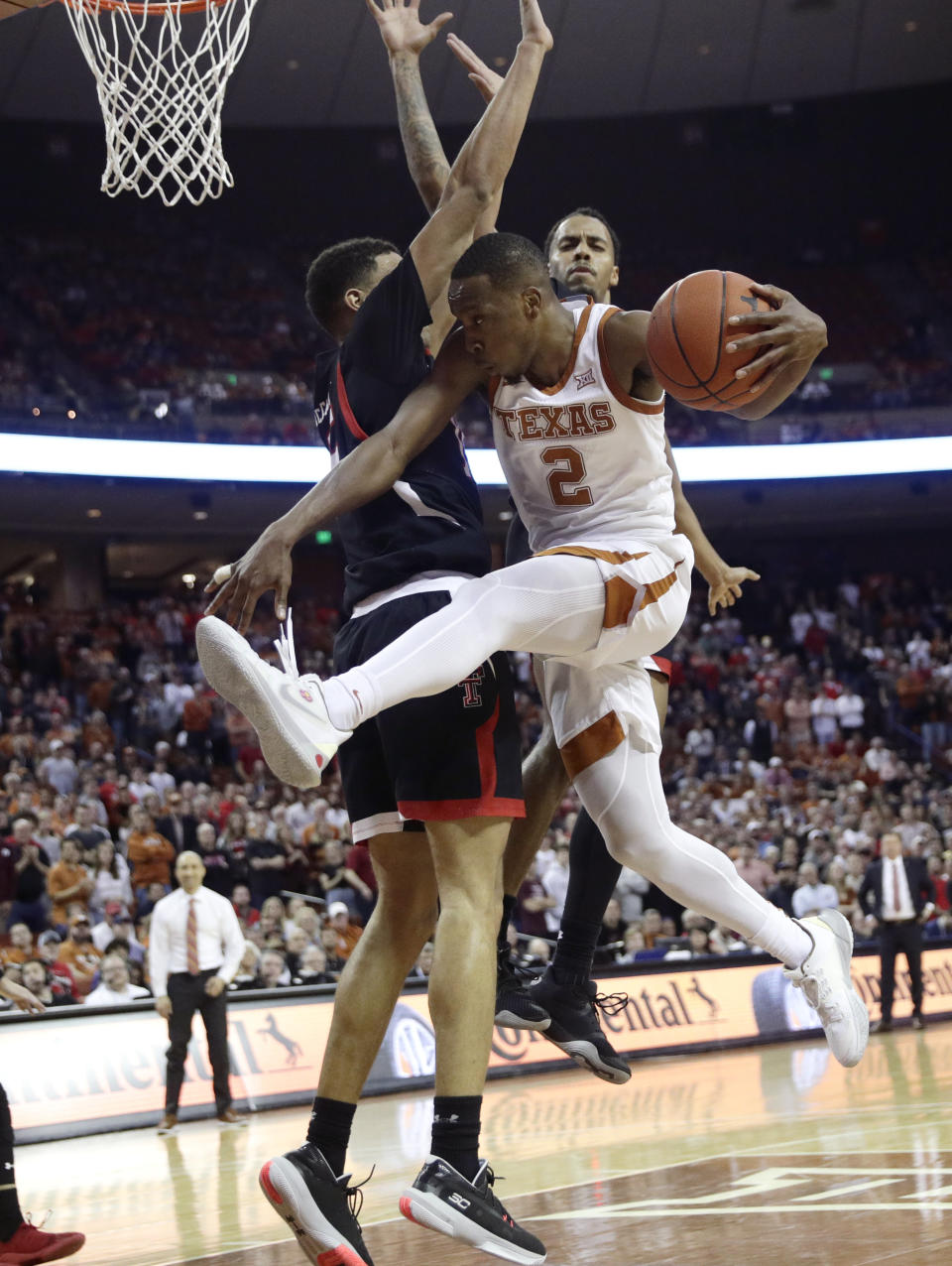 Texas guard Matt Coleman III (2) is blocked by Texas Tech guard Kevin McCullar, left, as he drives to the basket during the second half of an NCAA college basketball game, Saturday, Feb. 8, 2020, in Austin, Texas. Texas Tech won 62-57. (AP Photo/Eric Gay)