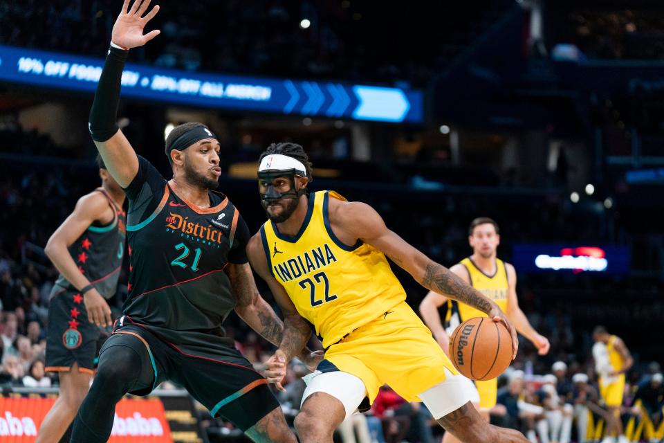 Indiana Pacers forward Isaiah Jackson (22) drives past Washington Wizards center Daniel Gafford (21) during the first half of an NBA basketball game, Friday, Dec. 15, 2023, in Washington. (AP Photo/Stephanie Scarbrough)