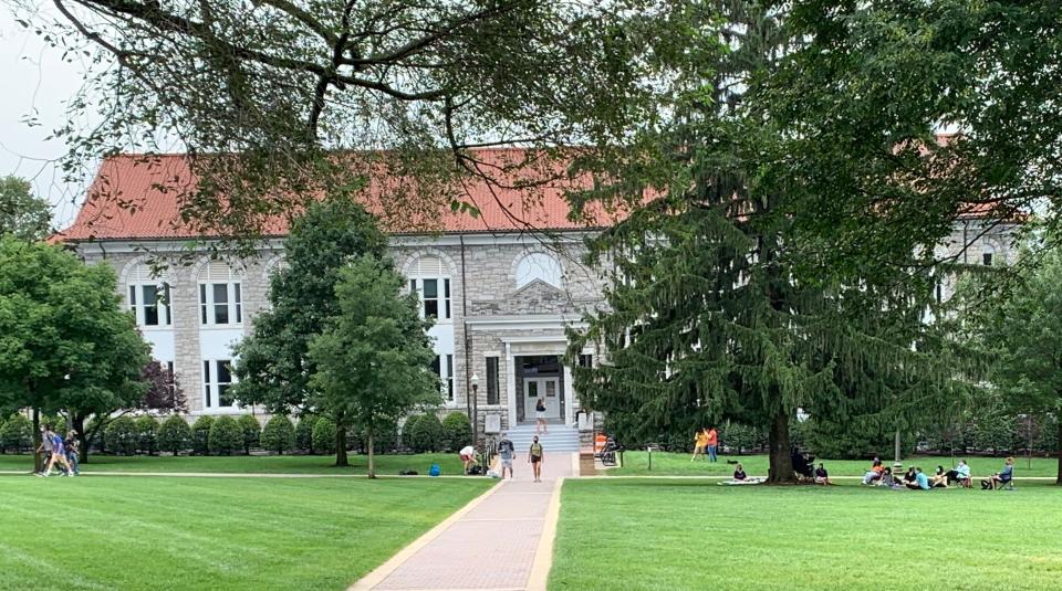 Students walk around the James Madison University campus on Tuesday.