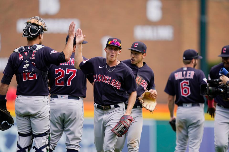 Cleveland Guardians center fielder Myles Straw greets team members after the 10th inning of a baseball game against the Detroit Tigers, Thursday, Aug. 11, 2022, in Detroit. (AP Photo/Carlos Osorio)