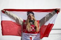 Snowboarding - Pyeongchang 2018 Winter Olympics - Women's Big Air Final Run 3 - Alpensia Ski Jumping Centre - Pyeongchang, South Korea - February 22, 2018 - Gold medallist Anna Gasser of Austria holds up the Austrian flag. REUTERS/Kim Hong-Ji