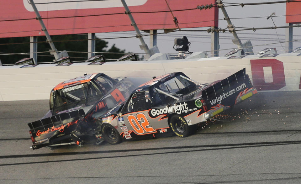 Kris Wright (02) and Codie Rohrbaugh (9) crash in Turn 2 during the NASCAR Truck Series auto race at Darlington Raceway, Friday, May 7, 2021, in Darlington, S.C. (AP Photo/Terry Renna)