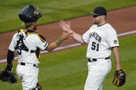 Pittsburgh Pirates relief pitcher David Bednar (51) celebrates with catcher Michael Perez after getting the final out of a baseball game against the Colorado Rockies in Pittsburgh, Monday, May 23, 2022. (AP Photo/Gene J. Puskar)