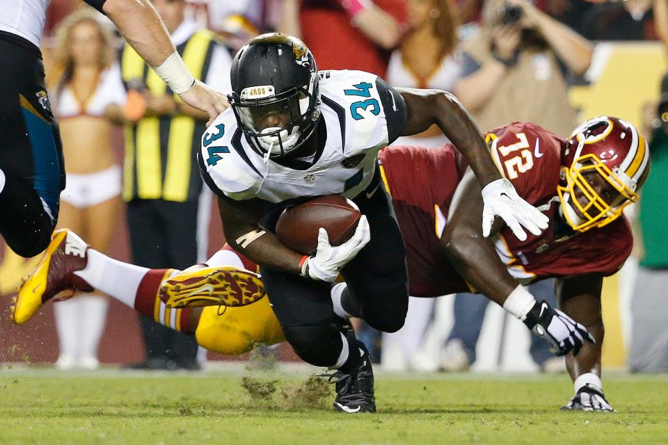Jacksonville Jaguars running back Storm Johnson (34) carries the ball past Washington Redskins nose tackle Jerrell Powe (72) during the third quarter at FedEx Field. The Jaguars won 17-16. Mandatory Credit: Amber Searls-USA TODAY Sports