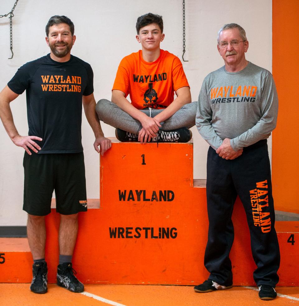 Three generations of Wayland wrestling Chases.  From left: current Wayland High School wrestling coach Sean Chase, sophomore wrestler, son, and grandson, Cole Chase, and former wrestler and coach, father and grandfather Gary Chase. 