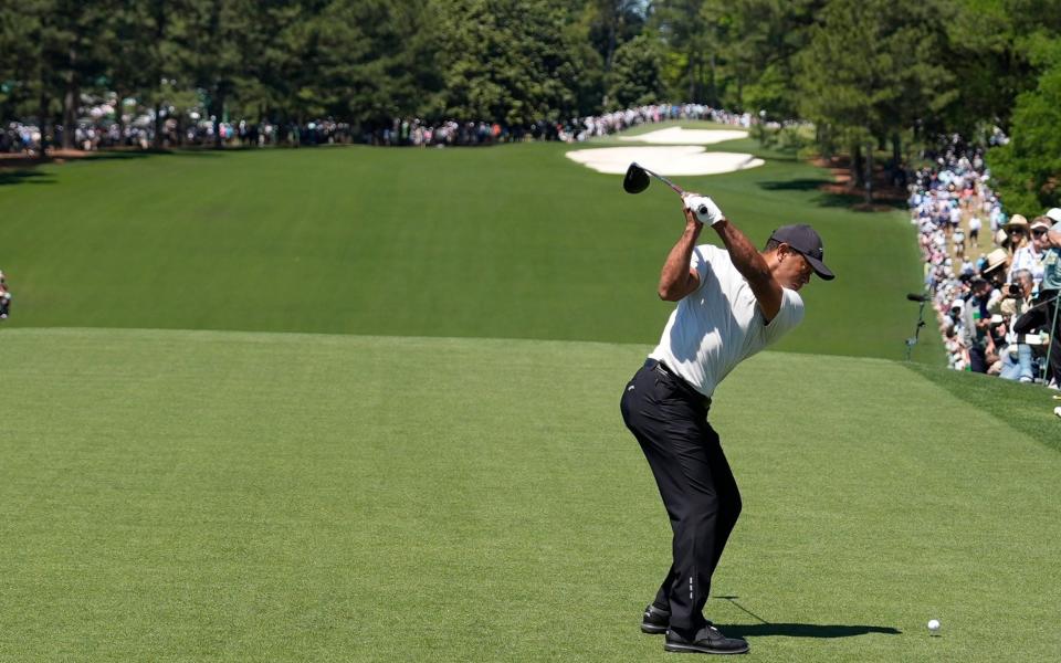 Tiger Woods tees off on the first