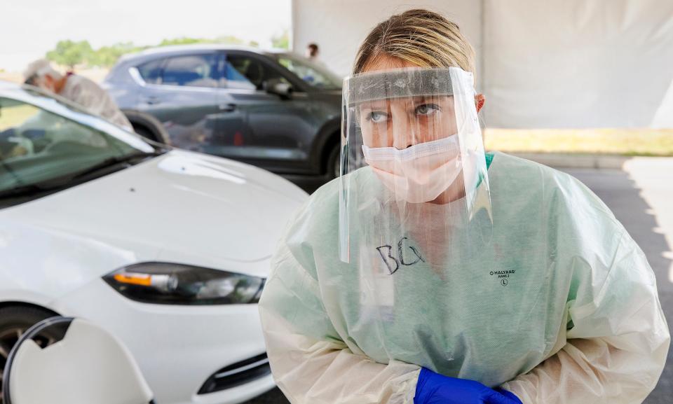 Advance provider Brittiany Garrett listens intently to a coworker’s question about a COVID-19 test sample at a mobile site in Fort Myers, Fla. The increasing number of people being tested requires nurses to pay extreme attention to detail when gathering and transporting test samples.