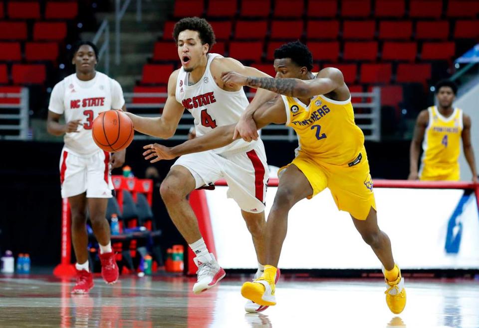 Pittsburgh’s Femi Odukale (2) fouls N.C. State’s Jericole Hellems (4) during the second half of N.C. State’s 65-62 victory over Pittsburgh at PNC Arena in Raleigh, N.C., Sunday, February 28, 2021.