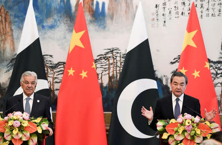 Pakistan’s Foreign Minister Khawaja Muhammad Asif (left) and Chinese State Councilor and Foreign Minister Wang Yi (right) have a press conference after their meeting at the Diaoyutai State Guest House in Beijing, China, April 23, 2018. Madoka Ikegami/Pool via Reuters