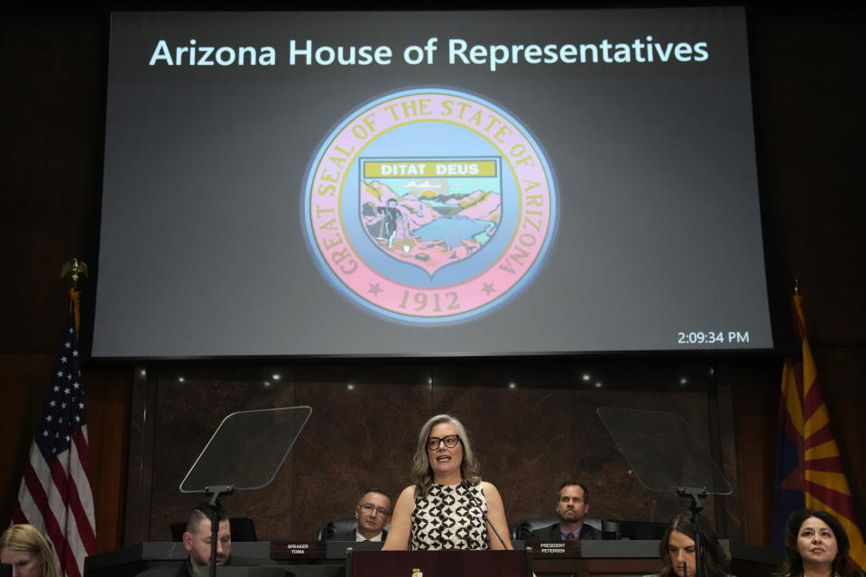 Arizona Democratic Gov. Katie Hobbs, center, delivers the State of the State address at the state Capitol, Monday, Jan. 8, 2024, in Phoenix. (AP Photo/Ross D. Franklin)