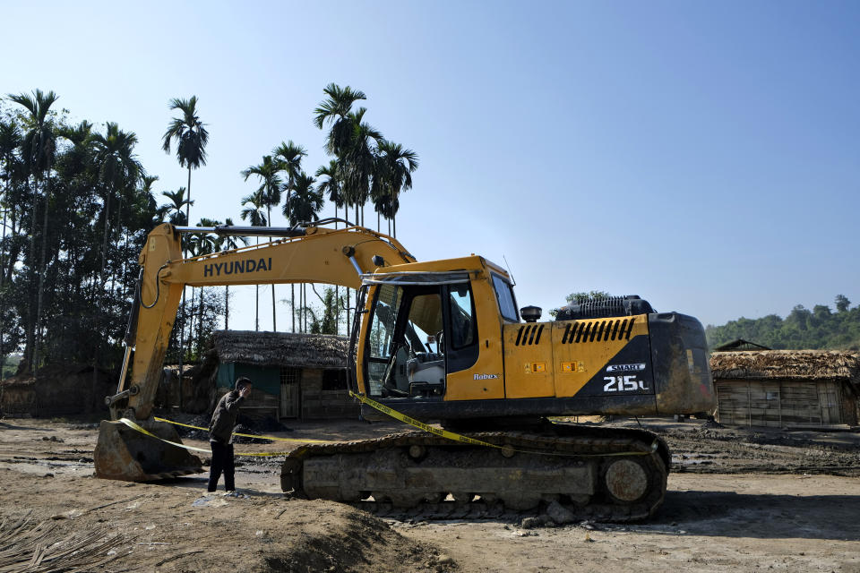 A boy looks at an earthmover where two civilians were killed in Tiru, near Oting, in the northeastern Indian state of Nagaland, Wednesday, Dec. 15, 2021. On Dec. 4, six civilians were killed when Indian army soldiers ambushed the truck they were travelling in. Later that day, seven men in a search party were also killed by the soldiers. “I was helping others unload the bodies from the truck when the soldiers started firing. I ran for my life and took refuge inside an earthmover. Two people hiding with me got killed. When the soldiers started shooting in our direction, I ran,” said Phonai, a coal miner and part of the search team who survived. (AP Photo/Yirmiyan Arthur)