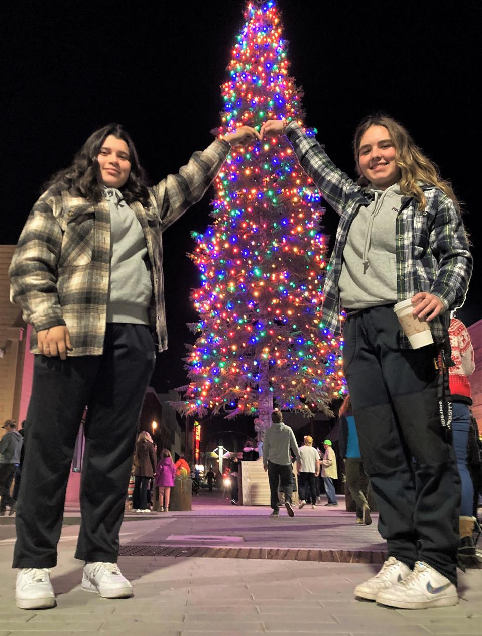 Simpson University students Nichole Martinez, left, and Charlie King pose in front of Redding's downtown Christmas tree after it was lit up Friday night, Dec. 3, 2021.