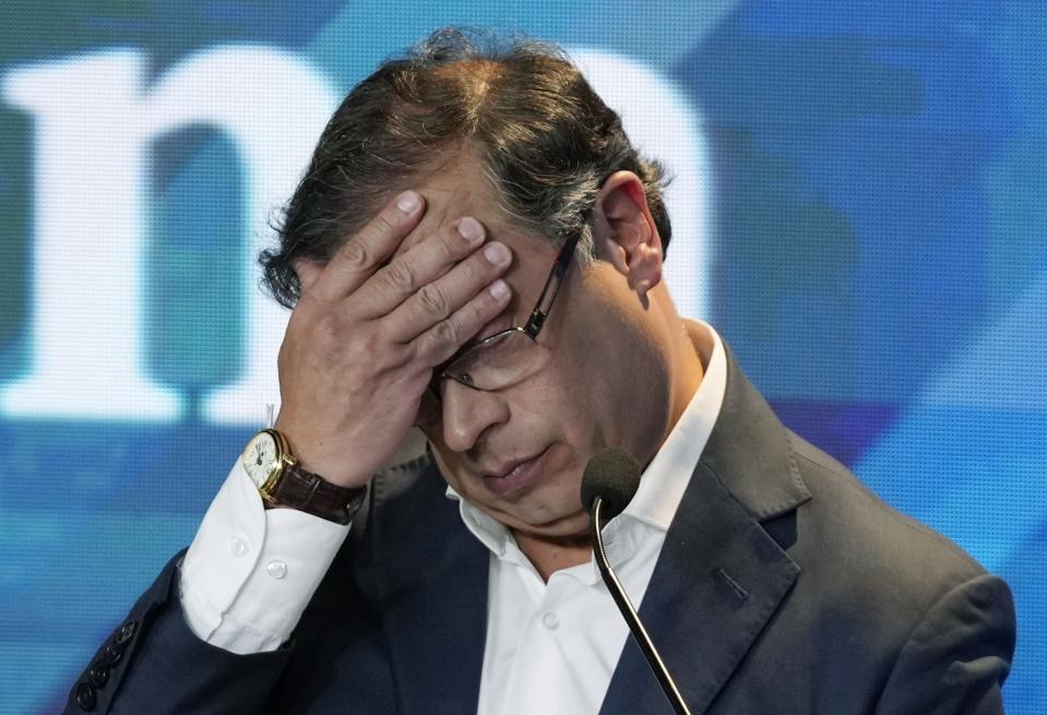 Presidential candidate Gustavo Petro, with the Historical Pact coalition, touches his forehead during a presidential debate held at the El Tiempo newspaper building in Bogota, Colombia, Monday, May 23, 2022, ahead of first round May 29th elections. (AP Photo/Fernando Vergara)