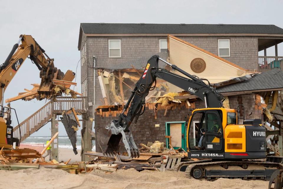 A demolition crew tears down a beach home Wednesday, Nov. 15, 2023 in Rodanthe. The National Park Service recently purchased two homes in Rodanthe as part of a pilot program to buy erosion-threatened properties and remove them before Mother Nature does.