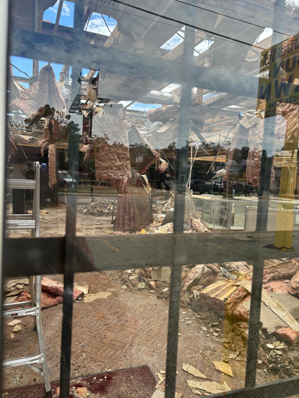 Internal damages to Tallahassee Gun & Pawn, observed through the window from outside the building.