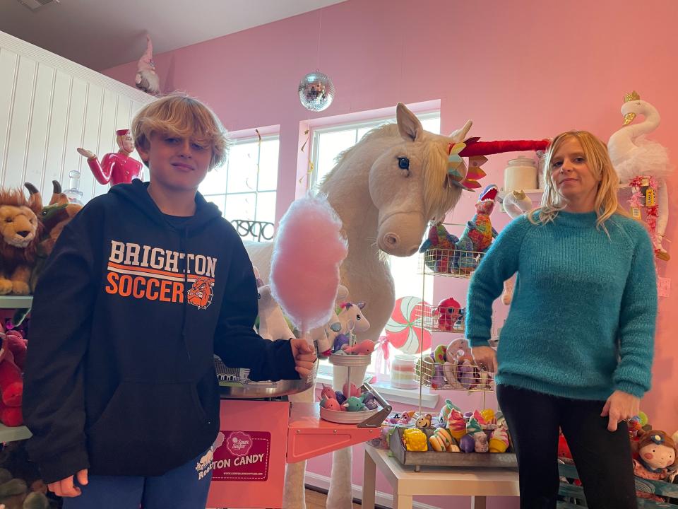 MJ Tamborini, 11, holds up cotton candy his mother, Spun Sugar Shoppe owner Mandy Tamborini, whipped up Tuesday, Dec. 19, 2023.