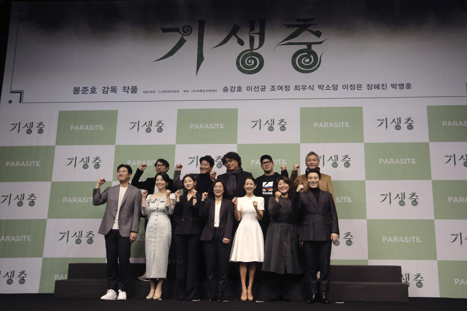 Bong Joon-ho, director of Oscar-winning “Parasite,” rear center, poses with the cast and crew after a press conference in Seoul, South Korea, Wednesday, Feb. 19, 2020. Bong said Wednesday “the biggest pleasure and the most significant meaning” that the film has brought to him was its success in many countries though the audiences might feel uncomfortable with his explicit description of a bitter wealth disparity in modern society. (AP Photo/Ahn Young-joon)