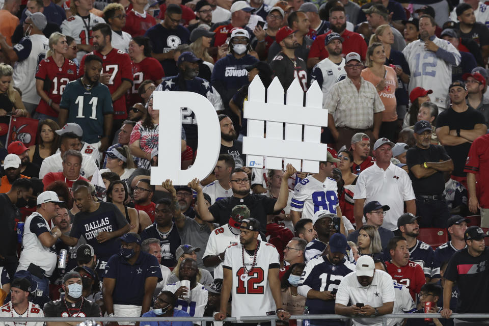 A Tampa Bay Buccaneers fan holds a sign during the first half of an NFL football game against the Dallas Cowboys Thursday, Sept. 9, 2021, in Tampa, Fla. (AP Photo/Mark LoMoglio)