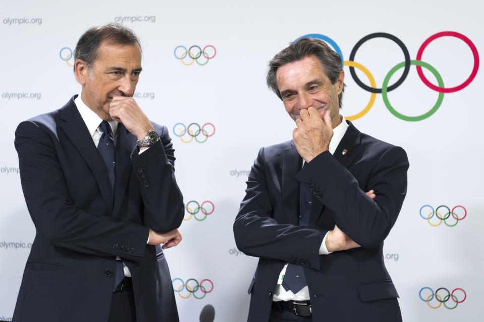 Mayor of Milan Giuseppe Sala and Italy's Lombardy region President Attilio Fontana, from left, talk during a press conference of the Milan-Cortina candidate cities the first day of the 134th Session of the International Olympic Committee (IOC), at the SwissTech Convention Centre, in Lausanne, Switzerland, Monday, June 24, 2019. The host city of the 2026 Olympic Winter Games will be decided during the134th IOC Session. Stockholm-Are in Sweden and Milan-Cortina in Italy are the two candidate cities for the Olympic Winter Games 2026. (Laurent Gillieron/Keystone via AP)