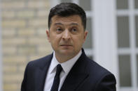 Ukrainian President Volodymyr Zelenskyy reacts during a press conference at the Ukrainian Embassy to France, Friday, April 16, 2021, in Paris. Ukrainian President Volodymyr Zelenskyy held talks with French President Emmanuel Macron and German Chancellor Angela Merkel amid his country's growing tensions with neighboring Russia, which has deployed troops near its border with Ukraine. (AP Photo/Lewis Joly)