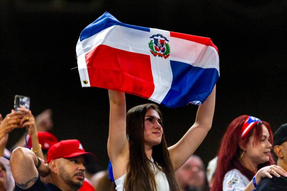 A Dominican Republic fan waves the DR flag from the stands during the fourth inning of a Caribbean Series baseball game at loanDepot park in Miami, Florida, on Saturday, February 3, 2024.