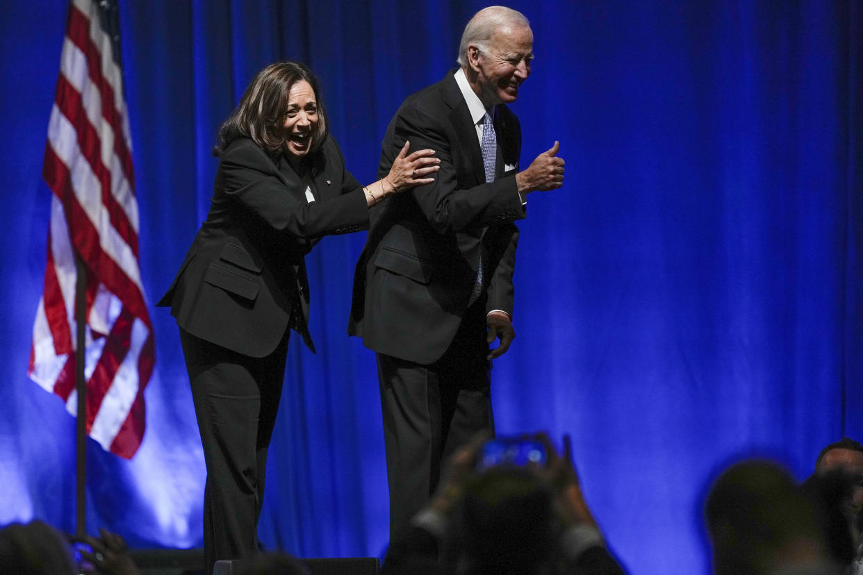 Vice President Kamala Harris holds onto President Joe Biden as he waves at the Pennsylvania Democratic Party's 3rd Annual Independence Dinner in Philadelphia, Friday, Oct. 28, 2022. (AP Photo/Matt Rourke)