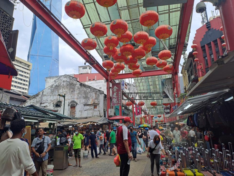 Red lanterns hanging over the crowd at Petaling Street