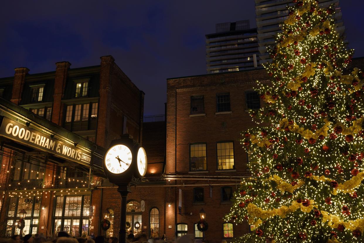 Distillery District Pipe Bridge and Clock with Toronto Christmas Market's decorated outdoor tree. (Photo by Education Images/Universal Images Group via Getty Images)