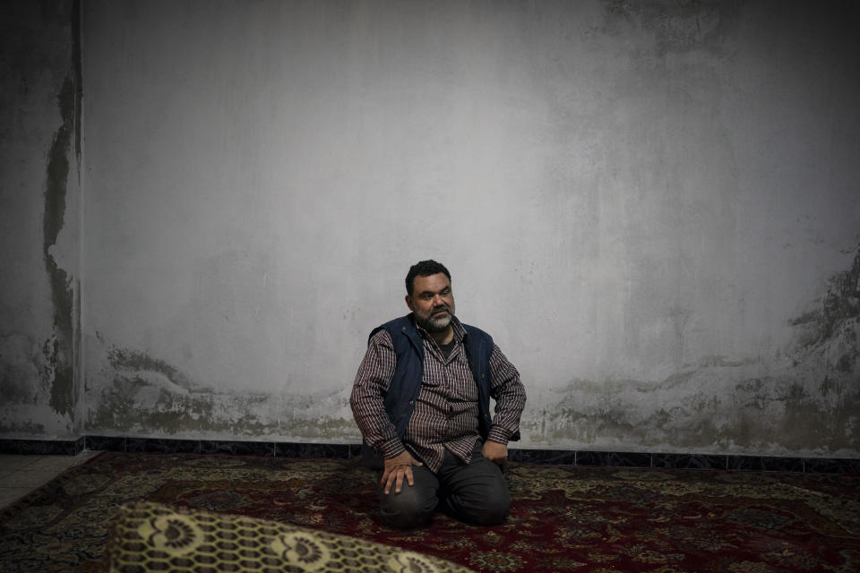 In this Thursday, March 12, 2020 photo, Yasser Alaboud, 45, poses for a photo inside his new home, in Idlib, Syria. Idlib city is the last urban area still under opposition control in Syria, located in a shrinking rebel enclave in the northwestern province of the same name. Syria’s civil war, which entered its 10th year Monday, March 15, 2020, has shrunk in geographical scope -- focusing on this corner of the country -- but the misery wreaked by the conflict has not diminished. (AP Photo/Felipe Dana)