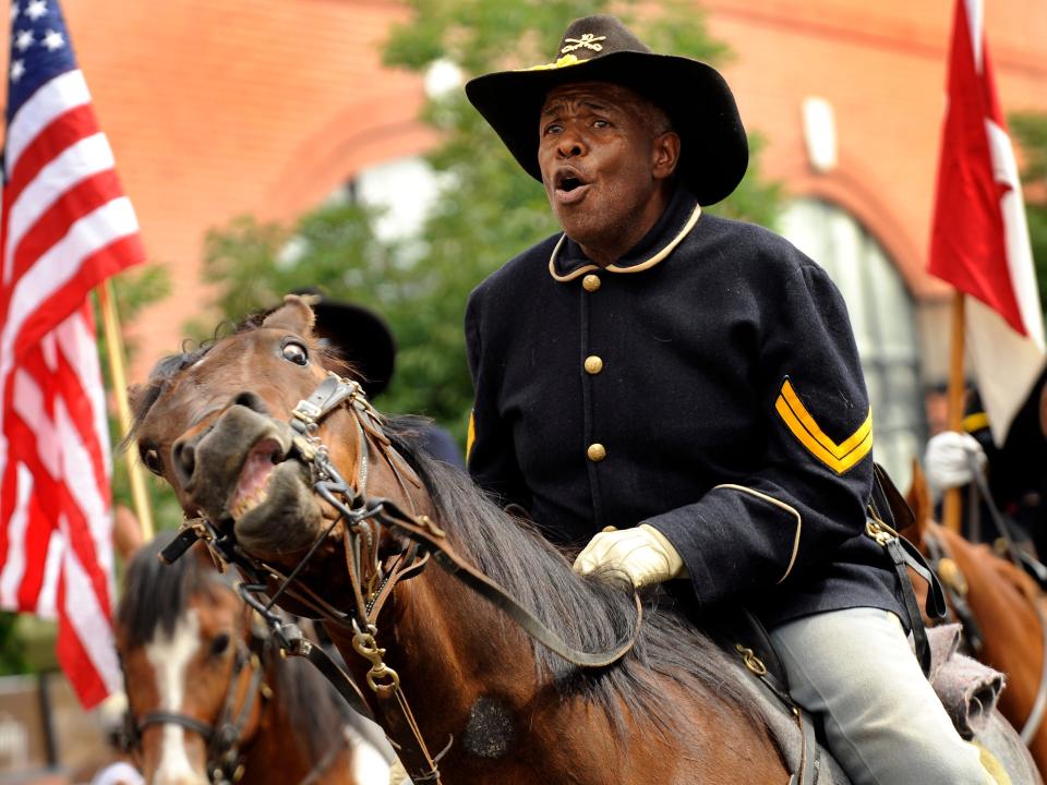 Jonas Felix leads the Buffalo Soldiers of the American West during the Juneteenth Parade, in the historic Five Points neighborhood, in Denver, CO.