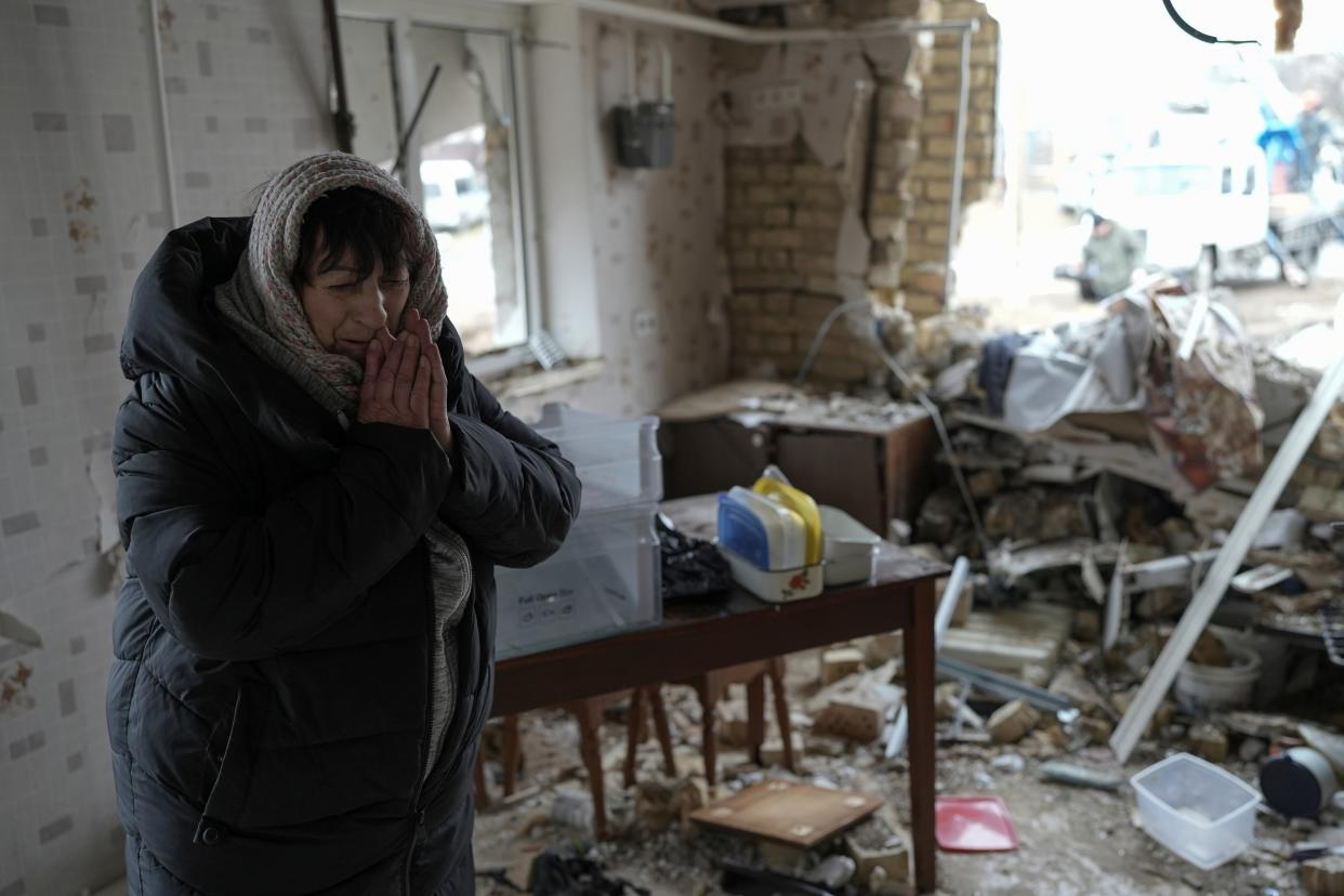 Halina Panasian, 69, reacts inside her destroyed house after a Russian rocket attack in Hlevakha, Kyiv region, Ukraine, Thursday, 26 January 2023 (AP)