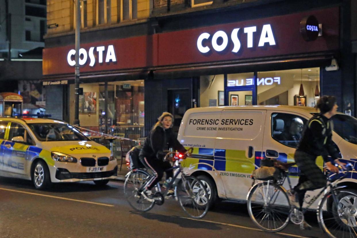 Police vehicles line the street where a crime scene was in place outside a Costa coffee shop following the double stabbing in Finsbury Park: NIGEL HOWARD ©