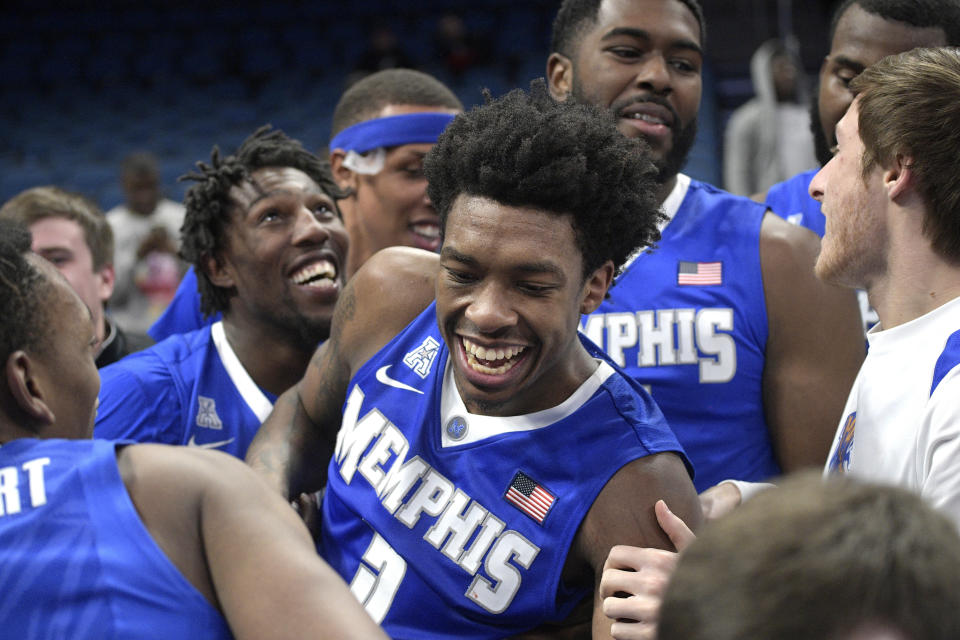 Kareem Brewton is swarmed by teammates after hitting the winning basket to beat Tulsa. (AP)