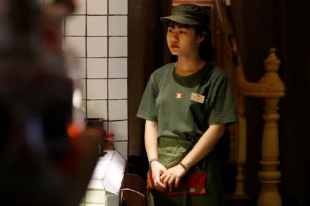 A waitress is seen resembling a Vietnamese soldier inside Cong Ca Phe, a popular cafe chain which uses communist-era propaganda in its branding in Hanoi, Vietnam January 28, 2019. REUTERS/Kham