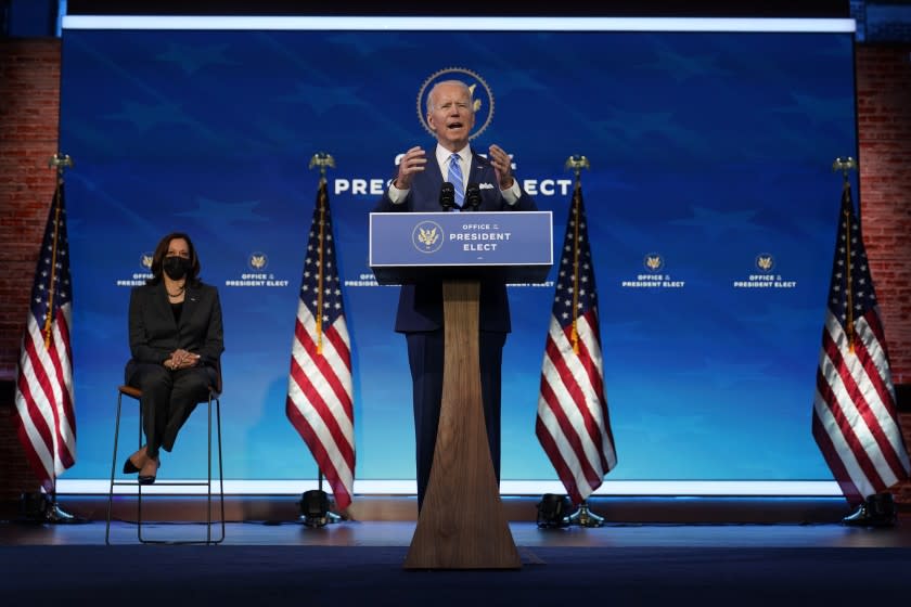 President-elect Joe Biden speaks during an event at The Queen theater as Vice President-elect Kamala Harris listens, Thursday, Jan. 14, 2021, in Wilmington. (AP Photo/Matt Slocum)