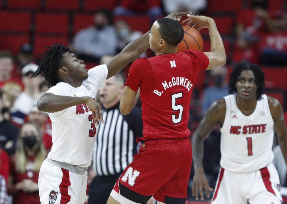 North Carolina State's Cam Hayes (3) pressures Nebraska's Bryce McGowens (5) during the first half of an NCAA college basketball game in Raleigh, N.C., Wednesday, Dec. 1, 2021. (Ethan Hyman/The News & Observer via AP)