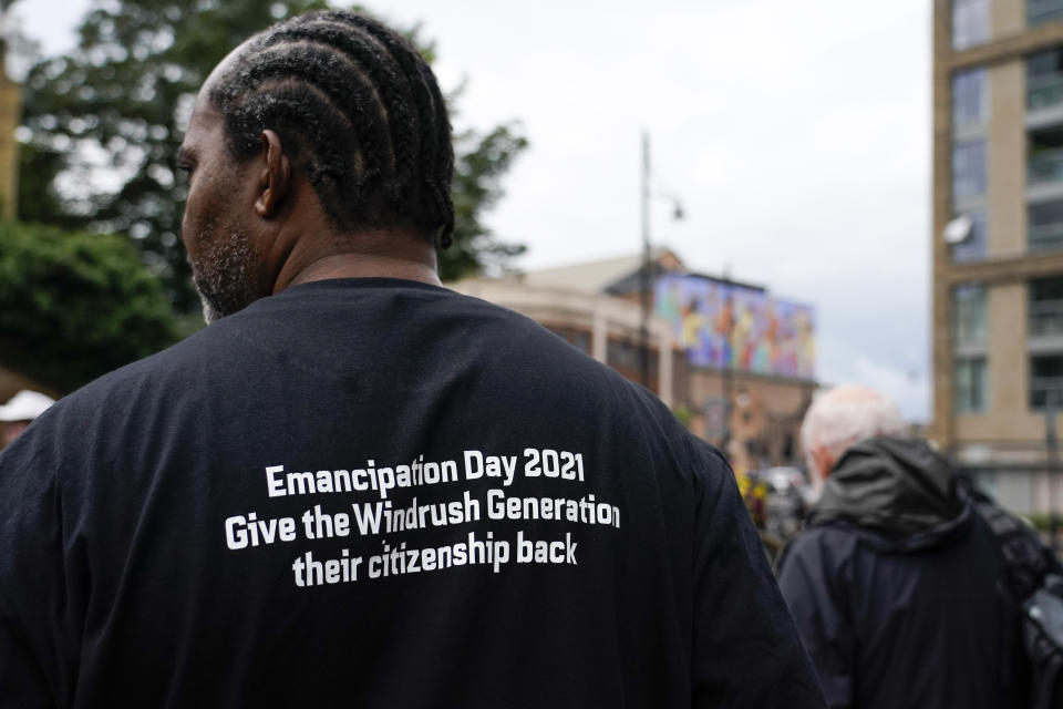 A demonstrator takes part in the annual Afrikan Emancipation Day Reparations march, in Brixton, London, Sunday, Aug. 1, 2021.Black people whose right to live in the U.K. was illegally challenged by the government marked the anniversary Sunday of the act that freed slaves throughout the British Empire, drawing a direct link between slavery and the discrimination they suffered. Dozens of campaigners gathered in Brixton, a center of the Black community in south London, to back the international drive for reparations for the descendants of enslaved Africans and demand legislation to compensate legal residents who were threatened with deportation in what is known as the Windrush Scandal. (AP Photo/Alberto Pezzali)